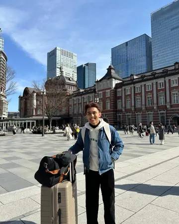 Naqiudin with a suitcase in front of Tokyo Station